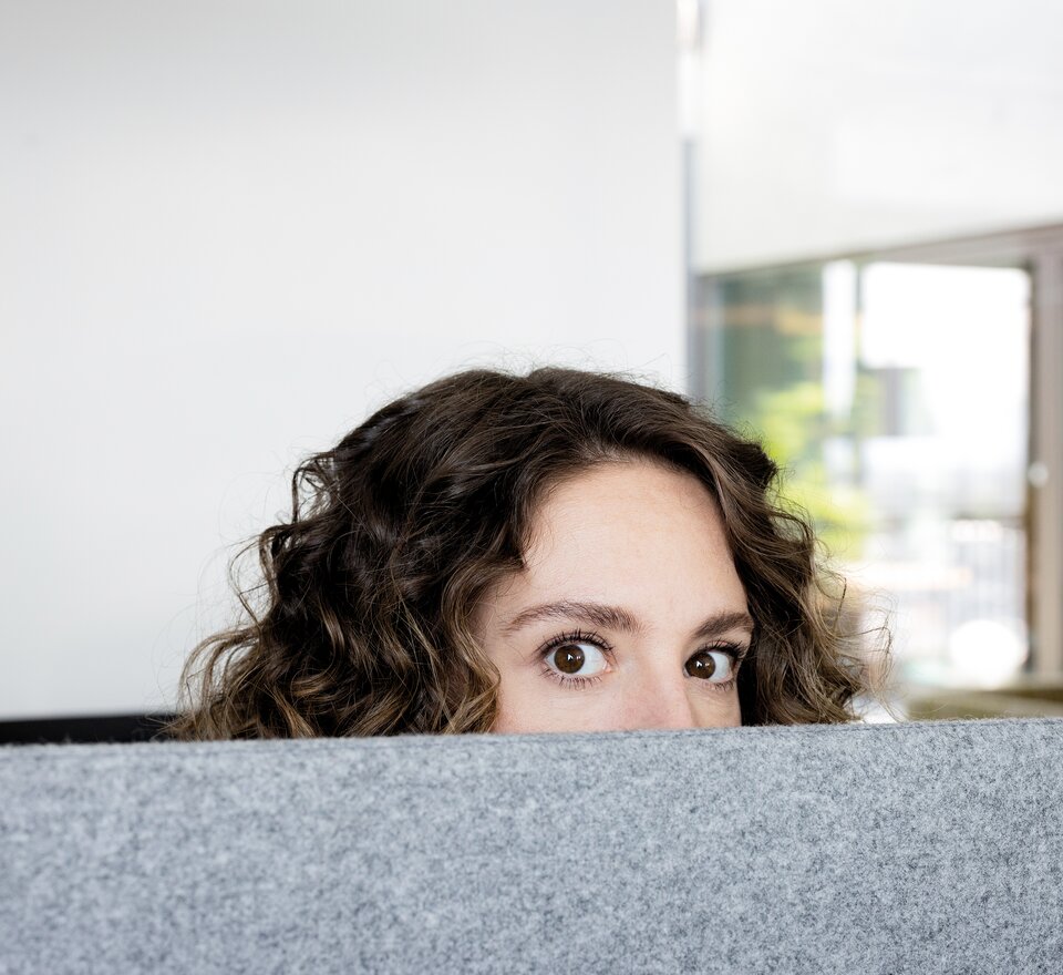 Person is hiding behind a desk.