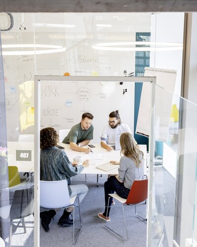 Four people in a creative room.