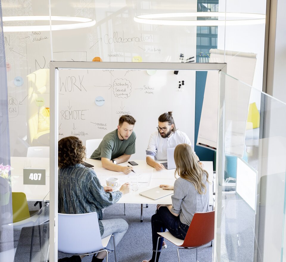 Four people in a creative room.