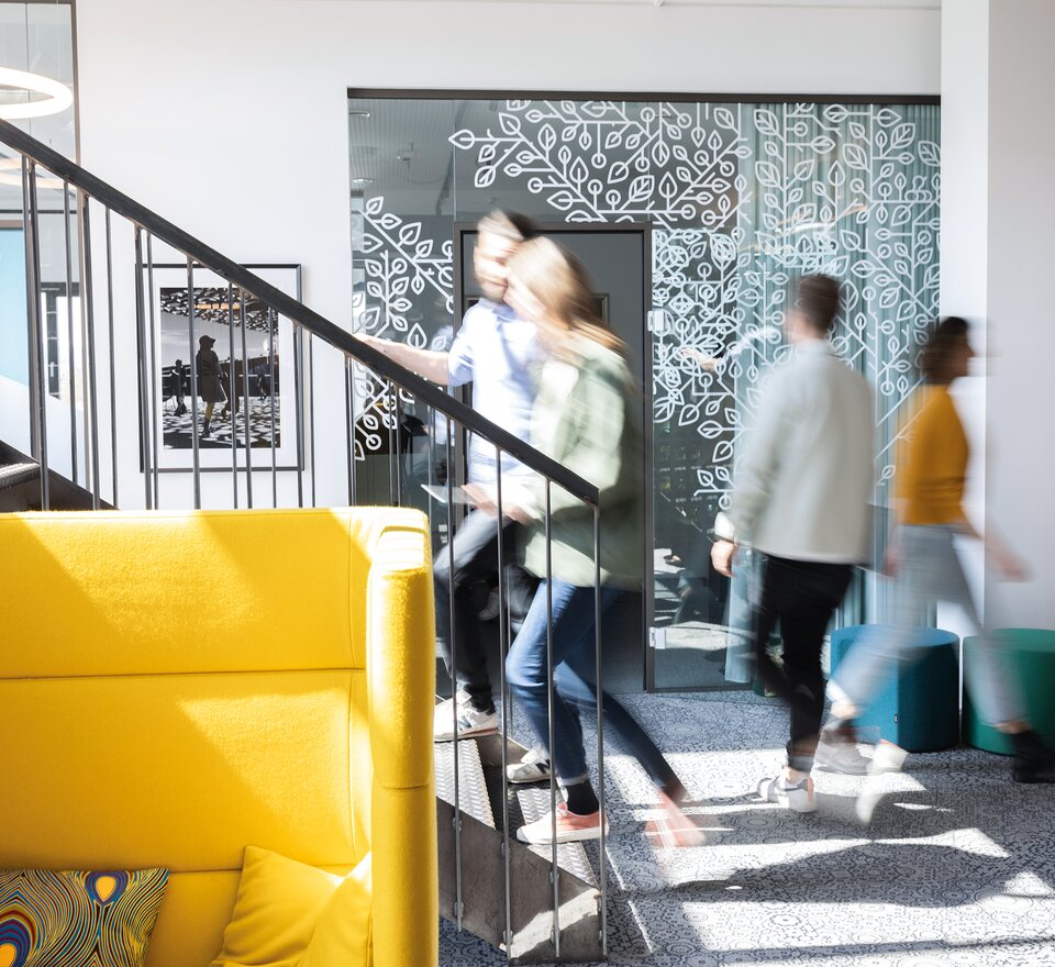 People walking around in an office.