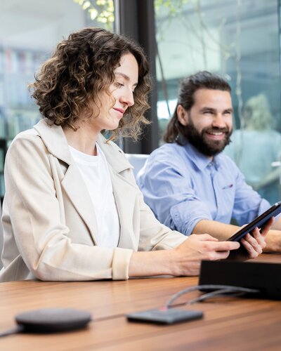 Two people in a conference room.