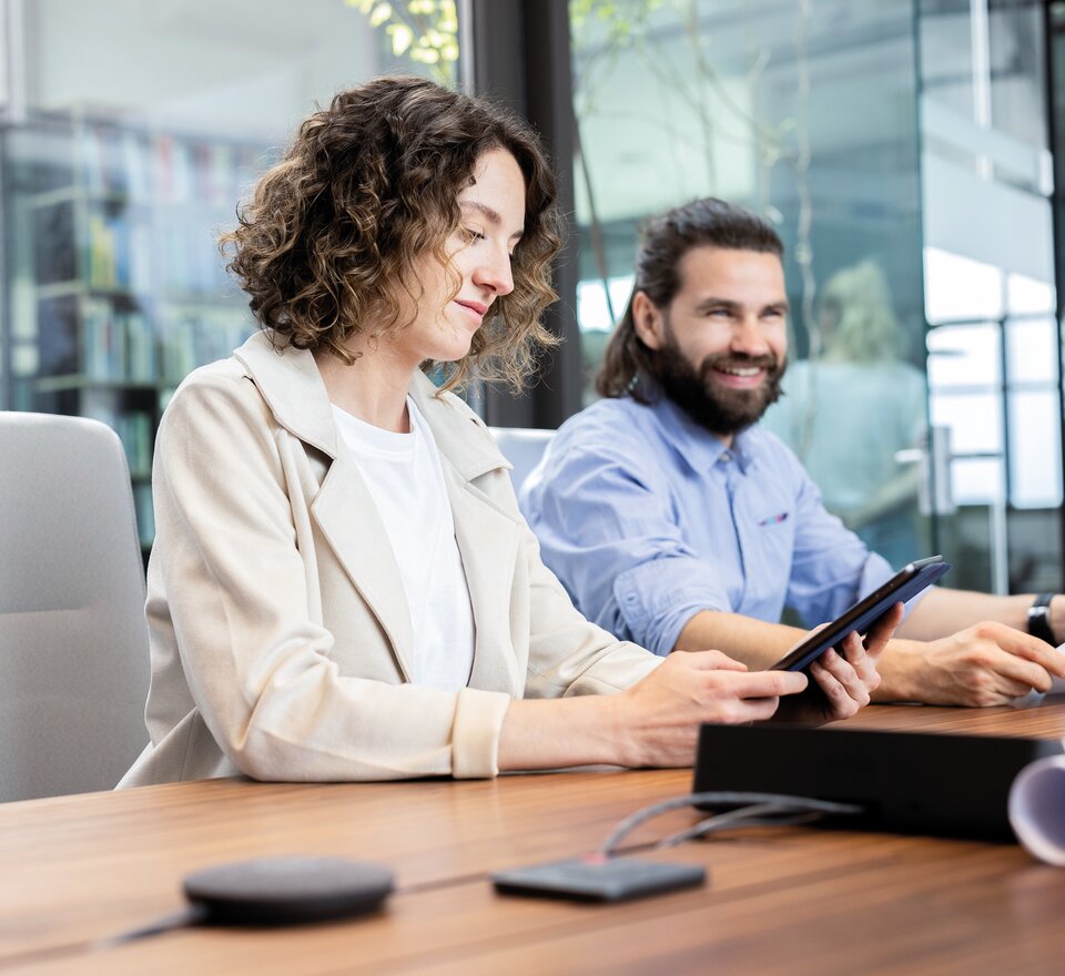 Two people in a conference room.