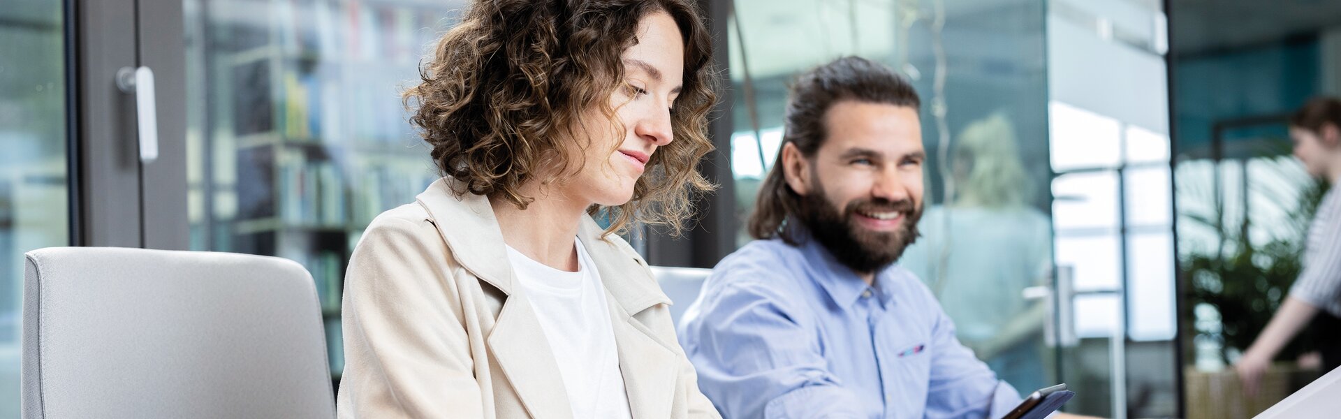 Two people in a conference room.