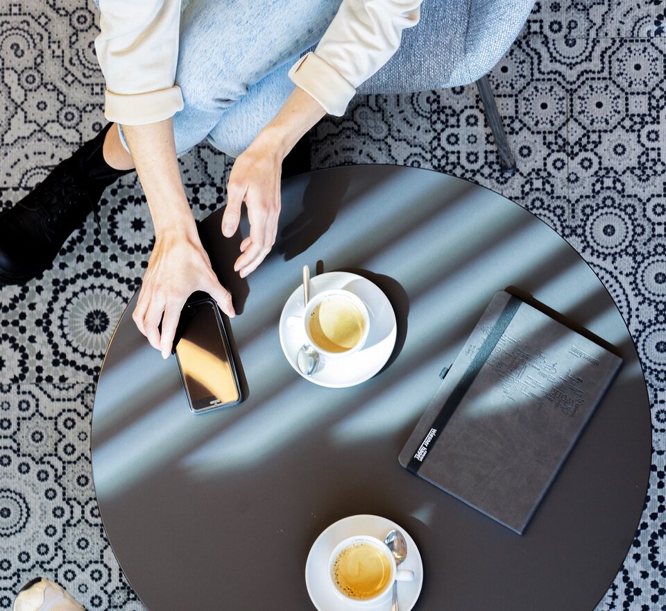 Two people sitting at a bistro table.