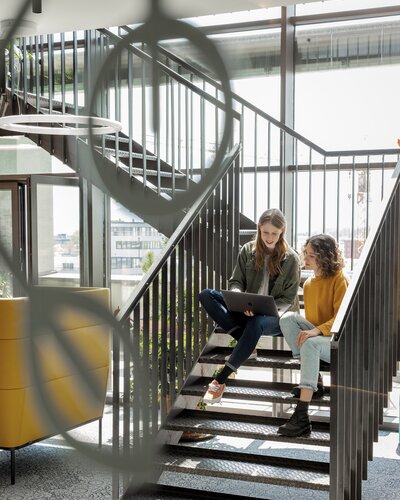 Two people working on stairs.