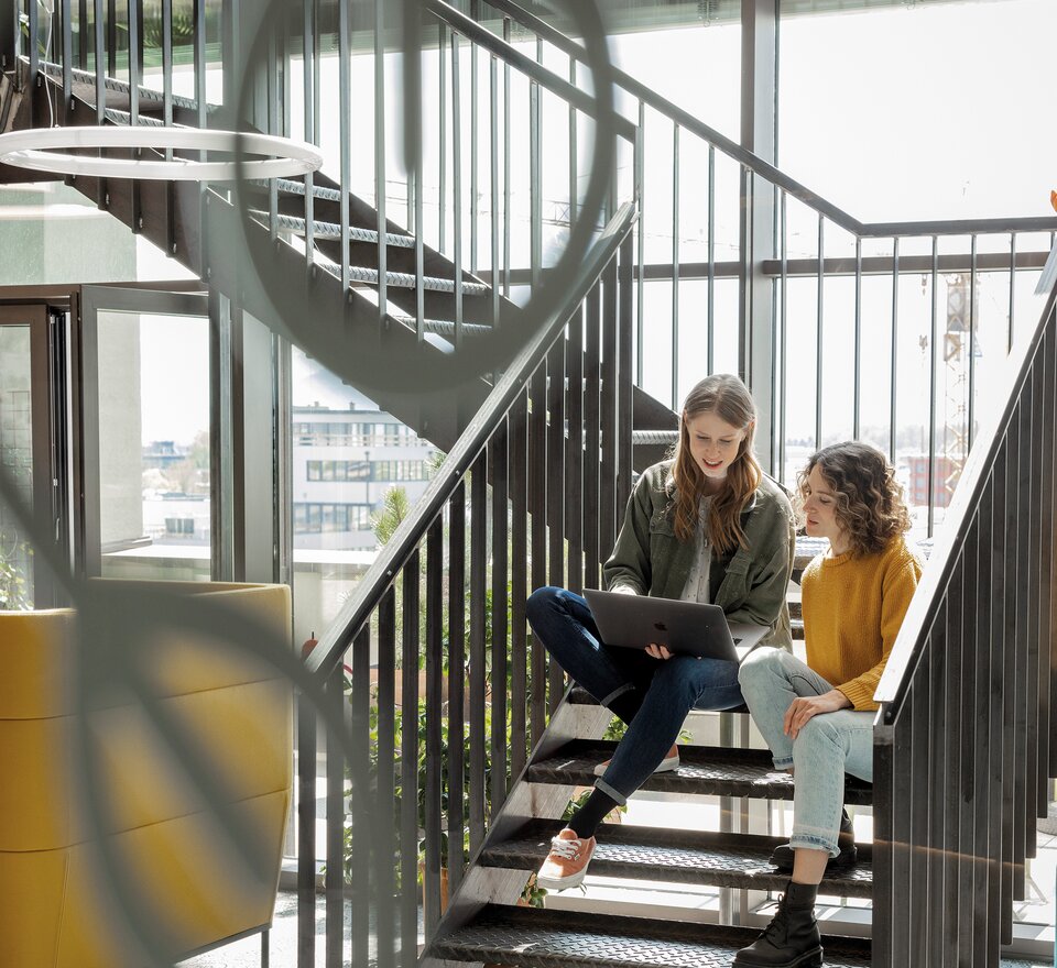 Two people working on stairs.