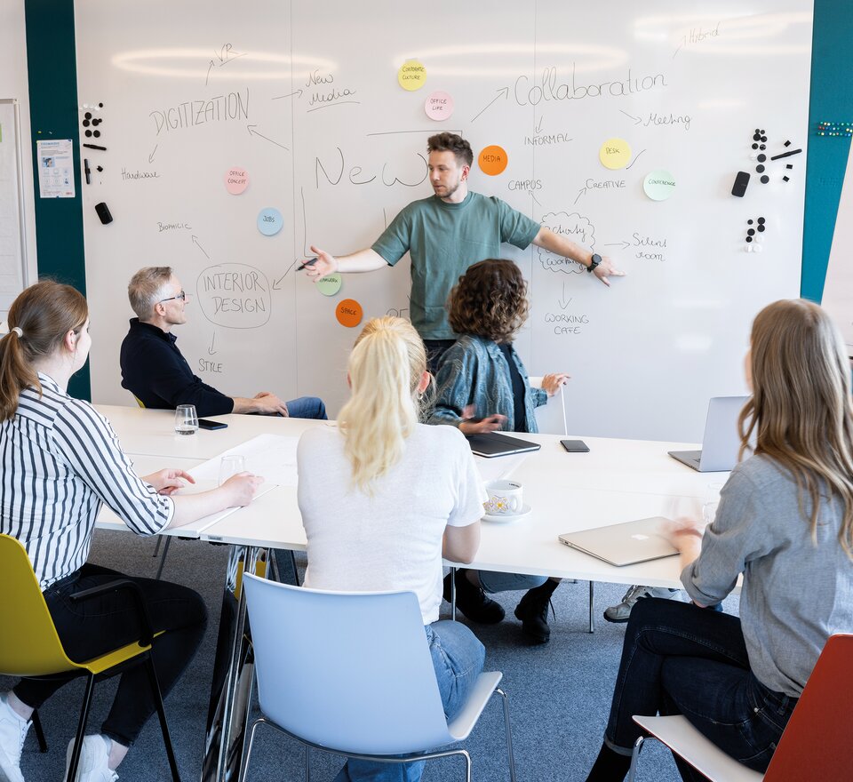 Eight people in a creative room.