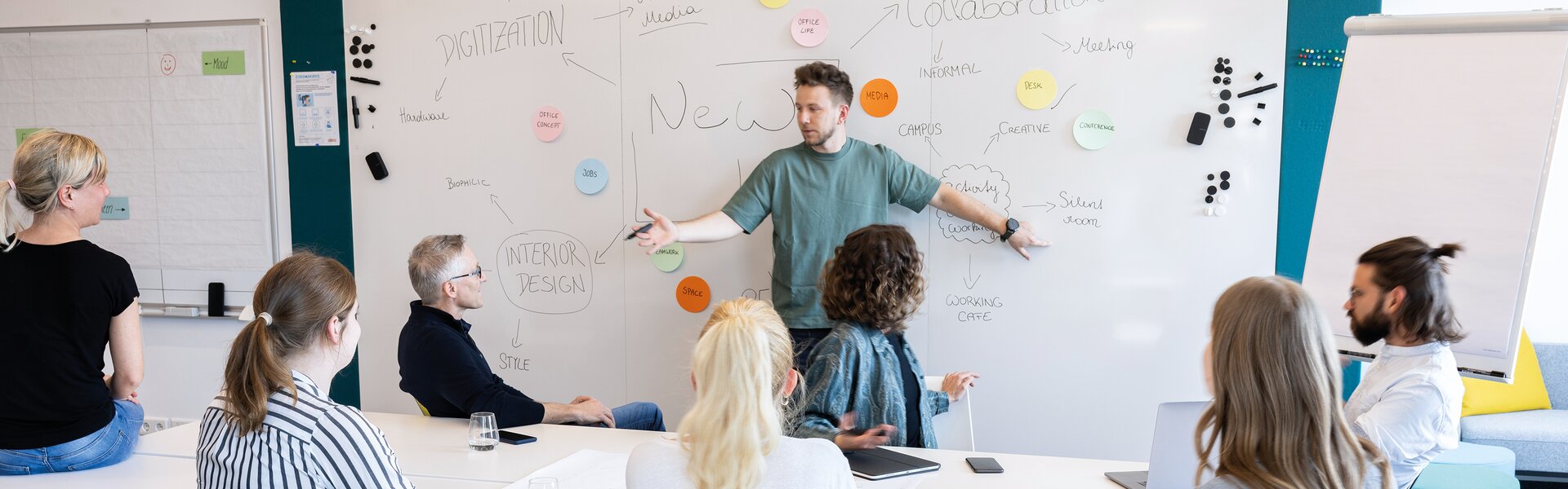 Eight people in a creative room.