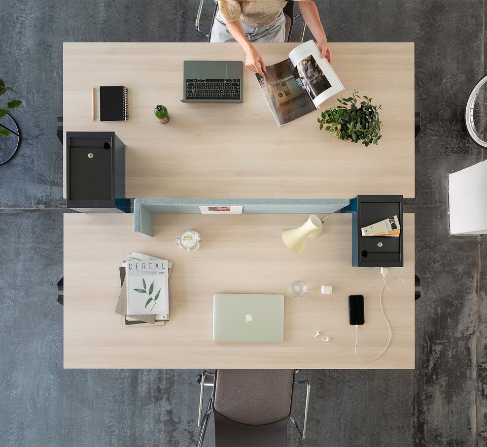 Two office desks photographed from above.