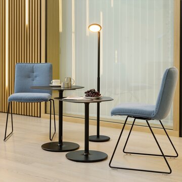 batch comfort skid-base chair Two blue padded skid-base chairs in front of a wooden wall.